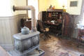 Wooten Patent Desk beside cast iron stove in drug store office at Mystic Seaport. Mystic, CT.