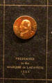 Gold button embossed with image of George Washington made in Waterbury, CT presented to Lafayette at Mattatuck Museum. Waterbury, CT.