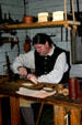 Leather craftsman at Colonial Spanish Quarter Museum. St Augustine, FL.