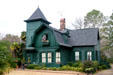 Green Dutch-colonial-style house in Tockwotton Historic District. Thomasville, GA.