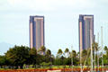 One Waterfront Towers over palm trees. Honolulu, HI.