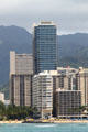Trump International Hotel & Condos towers above surrounding highrises. Waikiki, HI.