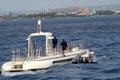Atlantis XIV submarine with Honolulu docks in distance. Waikiki, HI.