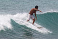 Wave riding surfers off Waikiki Beach. Waikiki, HI.