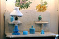 Blue glass vanity objects plus blue oil lamp with white glass shade at Dodge House. Council Bluffs, IA.