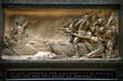 Bronze relief of Marquette holding up peace pipe to hostile native Americans "In vain I showed the calumet to explain that we had not come as enemies" on Marquette Building. Chicago, IL.