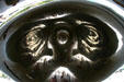 The concave underside surface of Cloud Gate in Millennium Park reflect people under the arch. Chicago, IL.