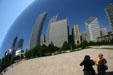 Photographer & friend take self portrait with city reflected off Cloud Gate sculpture in Millennium Park. Chicago, IL.