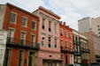 Multicolored heritage townhouses opposite St. Patrick's Church on Camp St. New Orleans, LA.