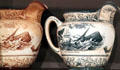 Ceramic pitcher by Buffalo Pottery showing capture of sperm whale at New Bedford Whaling Museum. New Bedford, MA.