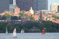 Gold-domed Statehouse, Beacon Hill over Charles River Basin. Boston, MA.