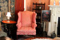 Wing chair beside parlor fireplace at Nichols House Museum. Boston, MA.