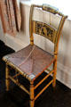 Hitchcock side chair with caned seat as stenciled by Rose Standish Nichols in rear bedroom at Nichols House Museum. Boston, MA.