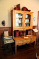 Kitchen cabinet beside beaten biscuit rolling machine at Vaile Mansion. Independence, MO.