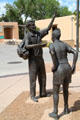 Explaining figures detail of Modern Art sculpture by Betty Sabo & Gary Beals at University of New Mexico. Albuquerque, NM.