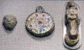 Late Bronze Age glass mask from Mesopotamia, star pendant from Iraq & Goddess Astarte pendant from Lebanon or Syria at Corning Museum of Glass. Corning, NY.