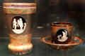 Bohemian Opaque Hyalith glass beaker with love allegories plus cup & saucer possibly by Anton Ambrosius Egermann of Haida at Corning Museum of Glass. Corning, NY.