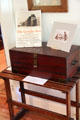 Roycroft Goodie Box made as gift hamper for Roycroft food items sits on Roycroft luggage rack from Roycroft Inn