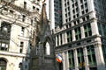 Gothic churchyard spire with Trinity & Equitable Buildings. New York, NY.