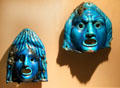 Faience miniature theatrical masks said to be from a burial at Medinet el-Fayum in Egypt at Metropolitan Museum of Art. New York, NY.