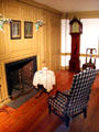 Parlor from Dr. Ezekiel Porter House with original Queen Anne-style three-sided chair of Wethersfield, CT & tall clock by Aaron Willard at Brooklyn Museum. Brooklyn, NY.