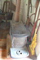 Antique cast iron Pine Knot wood stove by J.L. Mott Iron Works of New York in Layton General Store at Old Bethpage Village. Old Bethpage, NY.