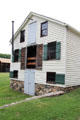 Luyster Store three-story rear facade with ground level storage where wagons unloaded at Old Bethpage Village. Old Bethpage, NY.