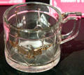 Commemorative glass mug in shape of drum with a gold eagle for U.S. Centennial Exhibition at McKinley Presidential Library & Museum. Canton, OH.