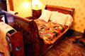 French Empire Revival bedstead with crazy quilt at Hower House. Akron, OH.