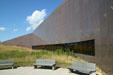 Wall of South Dakota State Historical Society Museum meets prairie grasses. Pierre, SD.