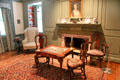 Card table with embroidered top & fireplace with portrait by John Singleton Copley in Queen Anne Suite at Bayou Bend. Houston, TX.