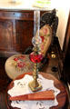Oil lamp beside side chair at Nichols-Rice-Cherry House at Sam Houston Park. Houston, TX.