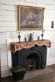 Fireplace with German pewter in San Felipe Cottage at Sam Houston Park. Houston, TX.