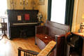 Piano & settee in Staiti House at Sam Houston Park. Houston, TX.