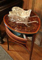 Silver whimsy wheelbarrow on heart-shaped table in library at McFaddin-Ward House. Beaumont, TX.