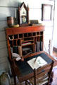 Drop-front desk with support cords & shelf clock in Mr. French's office at John Jay French Museum. Beaumont, TX.