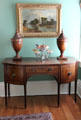 Curve-front sideboard with knife containers & silver fruit basket at Neill-Cochran House Museum. Austin, TX.