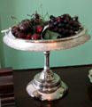 Antique bridle basket with fruit at Neill-Cochran House Museum. Austin, TX.