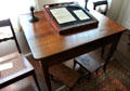 Walnut writing table with Biedermeier legs & children's foot stools below at Museum of Texas Handmade Furniture. New Braunfels, TX.