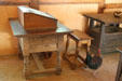 Chickens climb through desk in storehouse at Jamestown Settlement. Jamestown, VA.