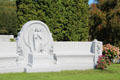 Granite bench with carved angel marks family grave in Barre cemetery. Barre, VT.
