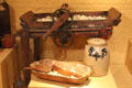 Roller butter worker to remove remaining milk over earlier wooden bowl & paddle plus stoneware butter crock at Billings Farm & Museum. Woodstock, VT.