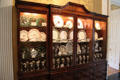 Breakfront displaying West Virginia & other china from the mansion's history in back hall at West Virginia Governor's Mansion. Charleston, WV.