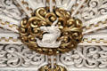 Detail of gilded medallion with sculpted plaster figure on ornate ceiling in Library at Penrhyn Castle. Bangor, Wales.