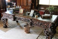Ornately carved large wooden desk in Library at Penrhyn Castle. Bangor, Wales.