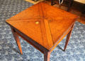 Light oak card table which can be enlarged by opening triangular flaps at Plas Newydd. Llangollen, Wales.