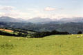 Sheep grazing with mountains in the background in Pentrefoelas. Pentrefoelas, Wales.