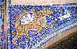 Mosaic showing tiger hunting deer on Shir Dor Madrasah at Registan mosque in Samarkand. Uzbekistan.