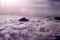 Volcanoes on the island of Java poke through the clouds. Indonesia.