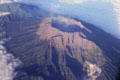Smoking volcano near the eastern end of Java seen from the air. Indonesia.